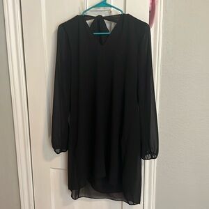 BCBG black cocktail dress. S. See thru sleeves, lined with overlay. Tie bow.